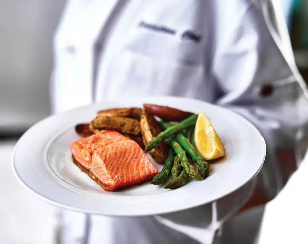 Bear Hollow Estates Chef Created Meals, chef delivering a finished dish.