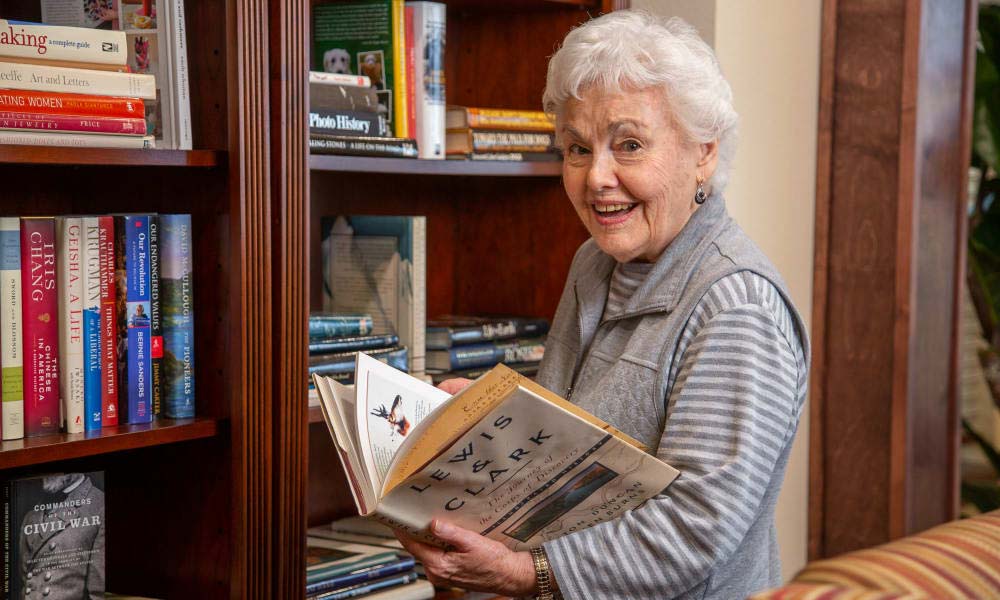 Independent senior near Sacramento selecting a book